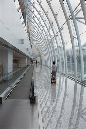 suitcase walking away - Woman with Luggage in Airport, Guangzhou, China Stock Photo - Rights-Managed, Code: 700-02263861