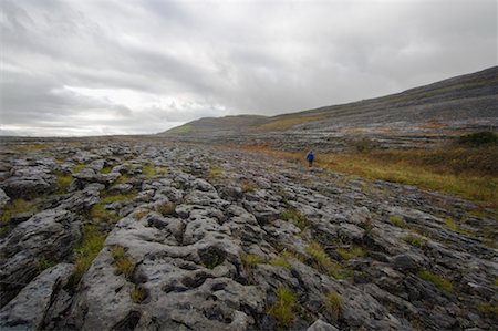 simsearch:700-02289029,k - Woman Hiking Across Field, Slieve Rua, Burren National Park, County Clare, Ireland Stock Photo - Rights-Managed, Code: 700-02289053