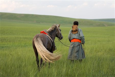 Horseman Walking with Horse, Inner Mongolia, China Stock Photo - Rights-Managed, Code: 700-02314933