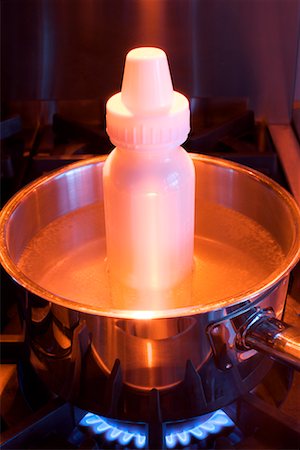 Heating Up Baby Bottle on Stove Stock Photo - Rights-Managed, Code: 700-02311043