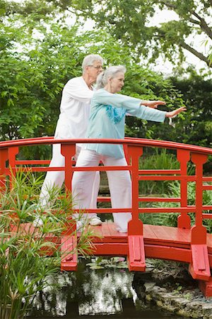 Couple Practicing Tai Chi on Footbridge Stock Photo - Rights-Managed, Code: 700-02332681