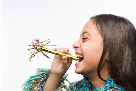 simsearch:693-06379982,k - Little Girl Blowing Noisemaker Stock Photo - Rights-Managed, Code: 700-02346372