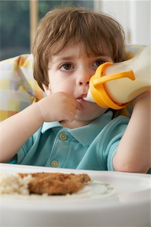 Boy with Baby Bottle in High Chair Stock Photo - Rights-Managed, Code: 700-02347725