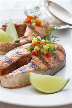 salmon steak - Grilled Salmon Steaks With Lime, Garnished With Peppers, Onions, Mango and Dill Stock Photo - Rights-Managed, Code: 700-02347858