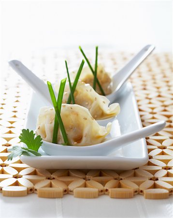 Chinese Dumplings With Sesame Seeds, Soy Sauce, and Chives Stock Photo - Rights-Managed, Code: 700-02347867