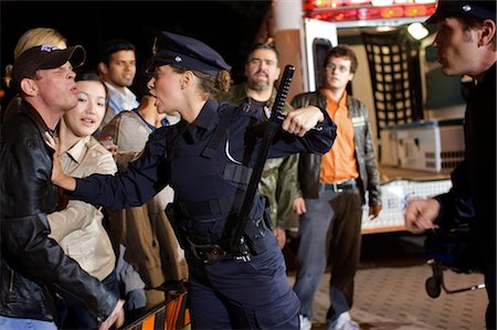 police woman standing - Police Calming Crowd at Accident Scene, Toronto, Ontario, Canada Stock Photo - Rights-Managed, Code: 700-02348237