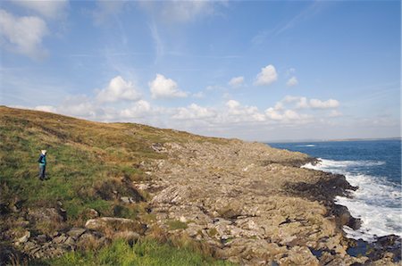 Woman Standing on Rocky Shoreline on Cape Clear Island, County Cork Ireland Stock Photo - Rights-Managed, Code: 700-02348614