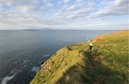 Woman Holding a Scarf, Running on a Hill by the Celtic Sea, Cape Clear Island, County Cork, Ireland Stock Photo - Rights-Managed, Code: 700-02348641