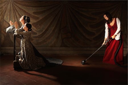 european traditional clothing - Medeival Maid Vaccuming by Praying Mother and Daughter Stock Photo - Rights-Managed, Code: 700-02376732