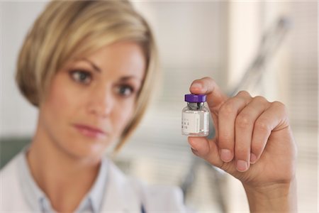 Doctor Holding Bottle of Medication Stock Photo - Rights-Managed, Code: 700-02377738