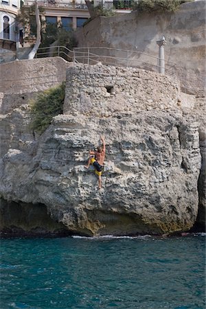 Man Free Climbing Up Small Cliff, Mallorca, Baleares, Spain Stock Photo - Rights-Managed, Code: 700-02371193