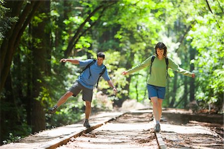 simsearch:700-02386017,k - Couple Balancing on Railroad Tracks in Forest, Santa Cruz, California, USA Stock Photo - Rights-Managed, Code: 700-02386010