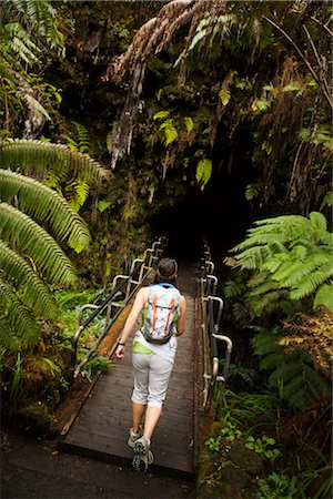 Hiker at Entrance to Lave Tube, Hawaii Volcanoes National Park, Big Island, Hawaii Stock Photo - Rights-Managed, Code: 700-02386191
