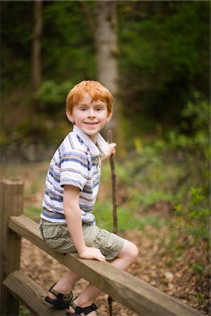 Boy Sitting on Fence Stock Photo - Rights-Managed, Code: 700-02386200