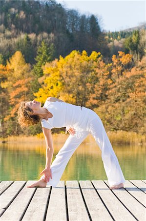 Woman Practicing Yoga on Dock, Fuschlsee, Salzkammergut, Salzburg, Austria Stock Photo - Rights-Managed, Code: 700-02428623