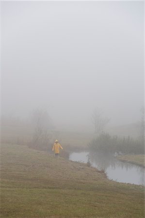 rainy season - Woman Walking in a Field in the Rain, Fuschl am See, Hof bei Salzburg, Salzburger Land, Austria Stock Photo - Rights-Managed, Code: 700-02428687