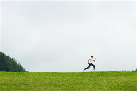 Man Running Across Field, Salzburger Land, Austria Stock Photo - Rights-Managed, Code: 700-02428725