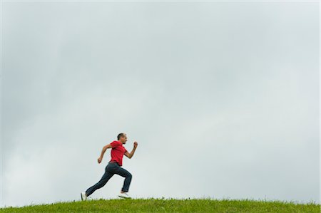 Man Running Across Field, Salzburger Land, Austria Stock Photo - Rights-Managed, Code: 700-02428727