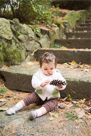 Girl with Pine Cone by Stone Steps Stock Photo - Rights-Managed, Code: 700-02586125