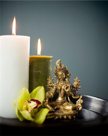 exotic relaxing - Vasudhara, Buddhist Goddess of Abundance and Fertility, Candles and Orchid Stock Photo - Rights-Managed, Code: 700-02594282