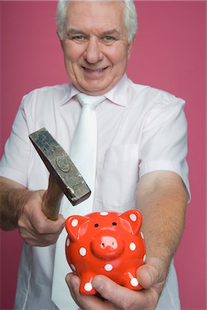 senior and saving - Man Holding Hammer and About to Break Piggy Bank Foto de stock - Con derechos protegidos, Código: 700-02637513