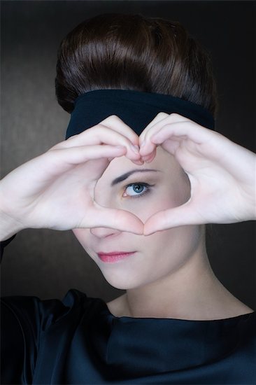 Portrait of Woman Making the Shape of a Heart With Her Hands Stock Photo - Premium Rights-Managed, Artist: Apolonia, Image code: 700-02637534