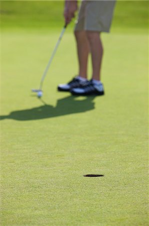foreground legs - Golfer Putting, Burlington, Ontario, Canada Stock Photo - Rights-Managed, Code: 700-02637608