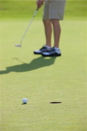 foreground legs - Golfer Putting, Burlington, Ontario, Canada Stock Photo - Rights-Managed, Code: 700-02637610