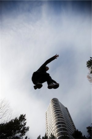 perspective buildings sunset - Man Practicing Parkour Seemingly Jumping Over a Building, Portland, Oregon, USA Stock Photo - Rights-Managed, Code: 700-02645666