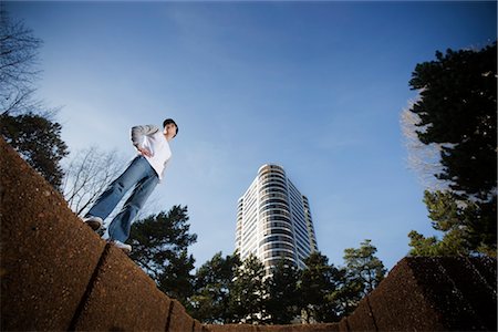 simsearch:700-02200635,k - Looking Up at Young Man Standing on Wall, Portland, Oregon, USA Stock Photo - Rights-Managed, Code: 700-02645680