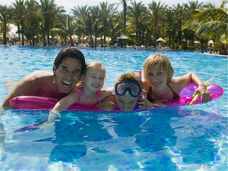 father and son swimming - Family Floating on Air Mattress Stock Photo - Rights-Managed, Code: 700-02645916