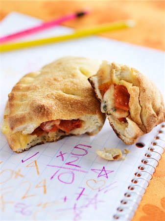 school lunch - Minature Calzone with School Work Stock Photo - Rights-Managed, Code: 700-02669179