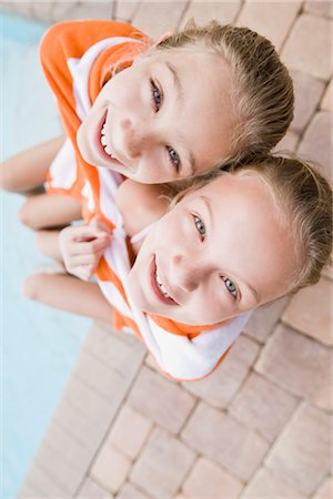 female sitting at edge of pool - Girls Sitting on Edge of Pool Stock Photo - Rights-Managed, Code: 700-02670788