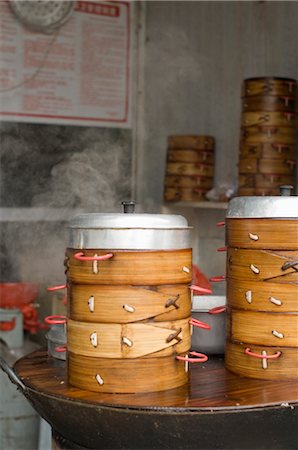 steam cooking - Bamboo Baskets Full of Steamed Dumplings at a Dim Sum Restaurant in Beijing, China Stock Photo - Rights-Managed, Code: 700-02698376