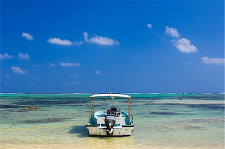 Boat Anchored in Shallow Water Surrounded by Coral Reefs, Ishigaki Island, Yaeyama Islands, Okinawa, Japan Stock Photo - Rights-Managed, Code: 700-02698391