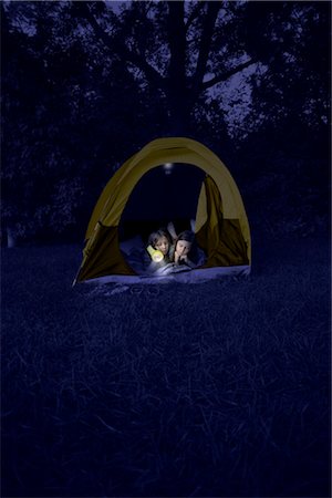flashlight - Girls in Tent at Night, Using Flashlight to Read Magazine Stock Photo - Rights-Managed, Code: 700-02698403