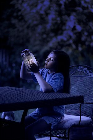 summer nostalgia - Girl Looking at Jar of Fireflies at Night Stock Photo - Rights-Managed, Code: 700-02698414