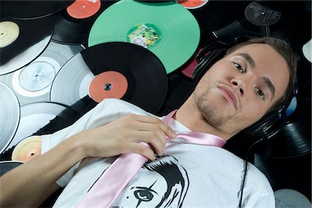 Man Lying on Pile of Records Stock Photo - Rights-Managed, Code: 700-02693768