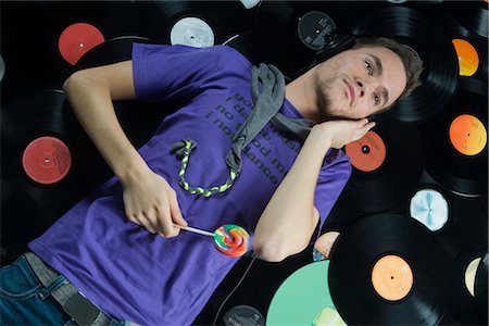 sound and image - Man Lying on Pile of Records Stock Photo - Rights-Managed, Code: 700-02693771