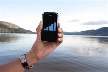 scenery with cellphone - Man Holding iPhone near Lake Stock Photo - Rights-Managed, Code: 700-02702587