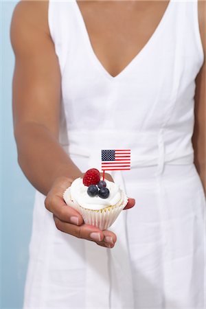 simsearch:600-06059756,k - Woman Holding Fourth of July Cupcake Stock Photo - Rights-Managed, Code: 700-02738544