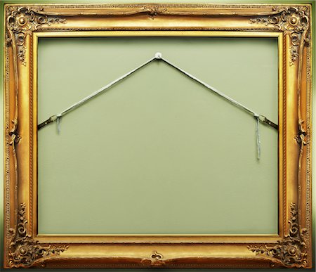 framed art on wall - Empty Picture Frame Hanging on Wall Stock Photo - Rights-Managed, Code: 700-02738776