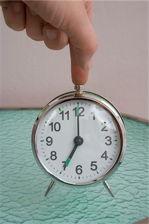 Woman Turning Off Alarm Clock Stock Photo - Rights-Managed, Code: 700-02756568