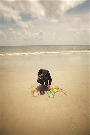 statistique - Homme d'affaires dessin graphique dans le sable sur la plage, Savannah, Georgia, USA Photographie de stock - Rights-Managed, Code: 700-02786844