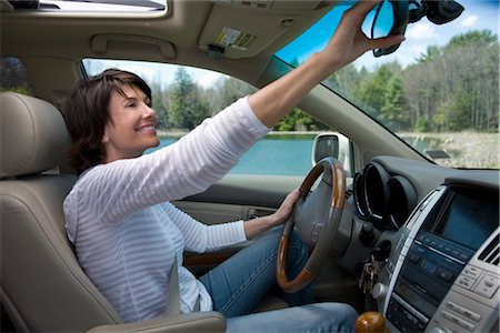 seatbelts - Driver Adjusting Rear-view Mirror Stock Photo - Rights-Managed, Code: 700-02833581