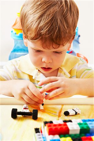 Boy Playing with Toy Building Blocks Foto de stock - Con derechos protegidos, Código: 700-02833644