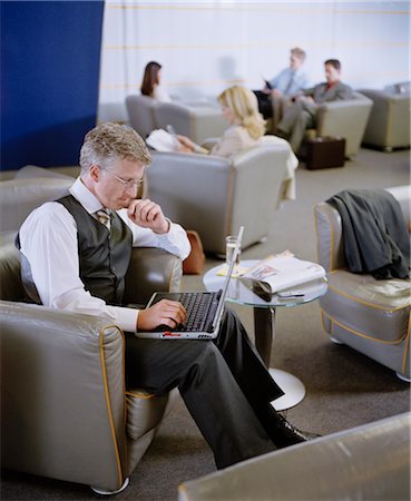 Businessman Using Laptop in Lounge Stock Photo - Rights-Managed, Code: 700-02887125