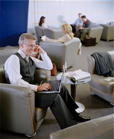 Businessman Using Laptop in Lounge Foto de stock - Con derechos protegidos, Código: 700-02887126