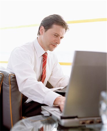 simsearch:700-02797980,k - Businessman using Laptop in Airport Stock Photo - Rights-Managed, Code: 700-02887146