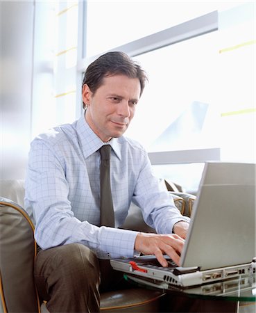 simsearch:700-02797980,k - Businessman using Laptop in Airport Stock Photo - Rights-Managed, Code: 700-02887147